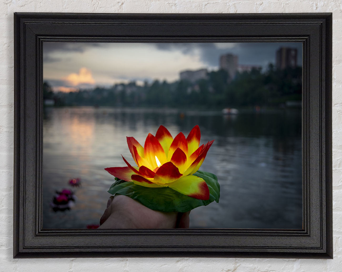 Flower candle in city view Framed Print