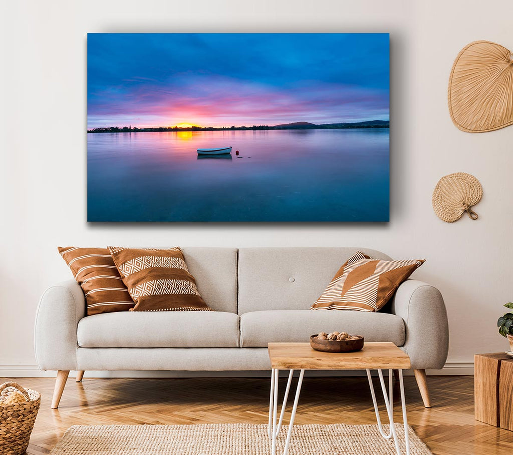 Small row boat on calm lake Canvas Wall Art